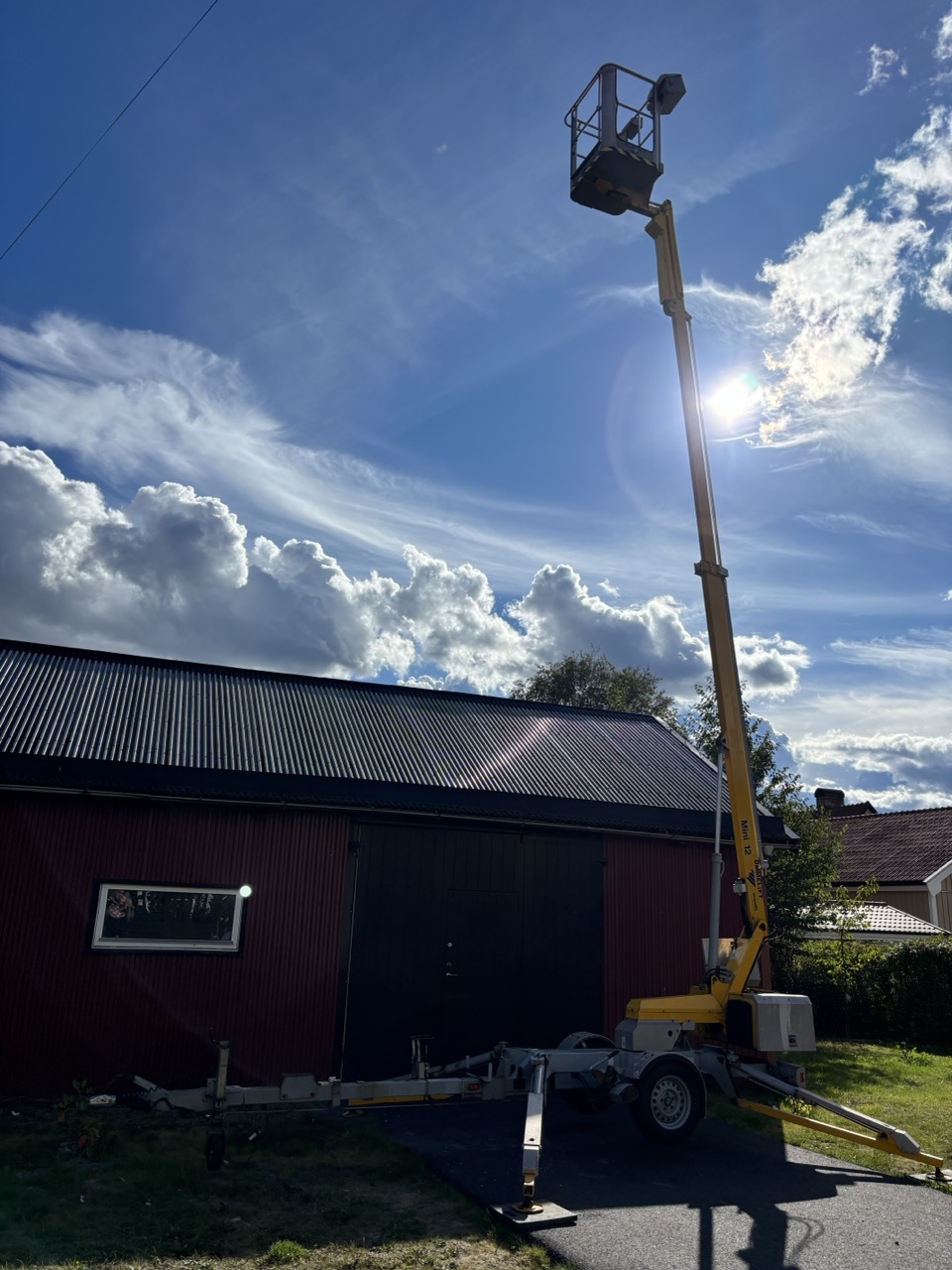 Skyliften med bommen uppfälld bredvid ett hus.